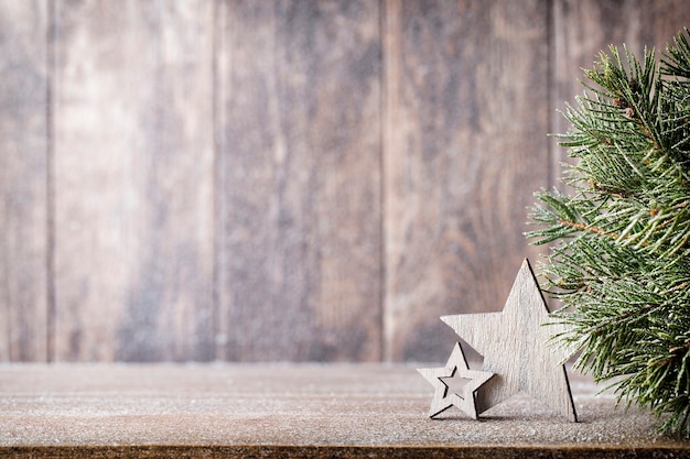 Christmas fir branch and decor, on the wooden background.