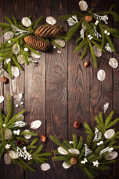 Christmas fir branches and decorations on dark wood