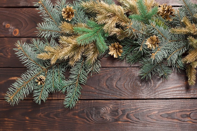 Christmas fir branches on old dark wooden background