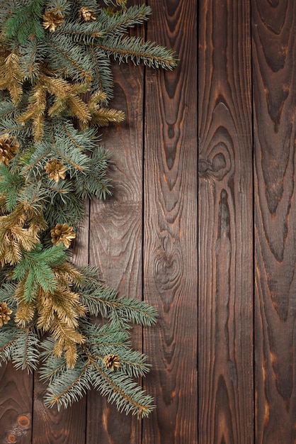 Christmas fir branches on old dark wooden background