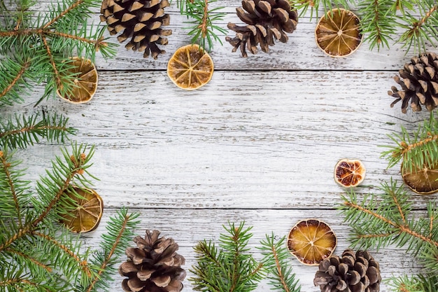 Christmas fir branches with cones and dry lemon slice