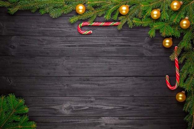 Christmas fir tree on black wooden background