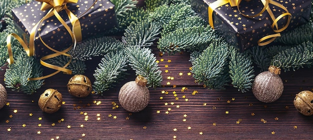 Christmas fir tree branches christmas balls gift box wooden\
snowflakes and stars on old brawn wooden background for your xmas\
greetings top view with copy space christmas greeting card\
banner