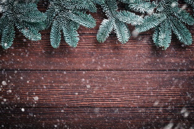 Christmas fir tree branches christmas balls gift box wooden
snowflakes and stars on old brawn wooden background for your xmas
greetings top view with copy space christmas greeting card