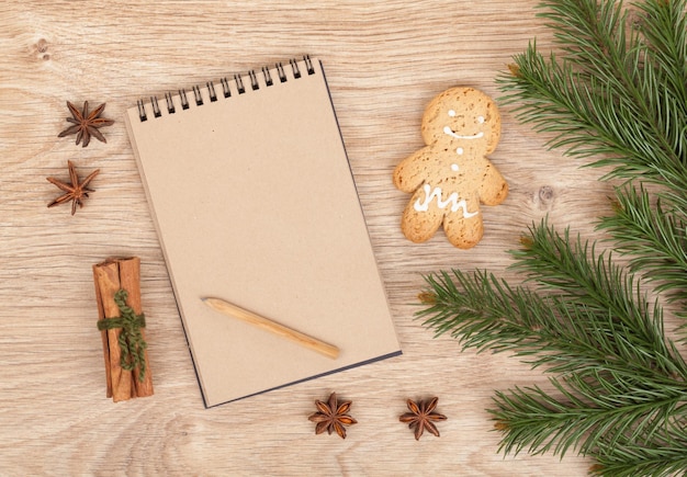 Christmas fir tree gingerbrean man and blank notepad