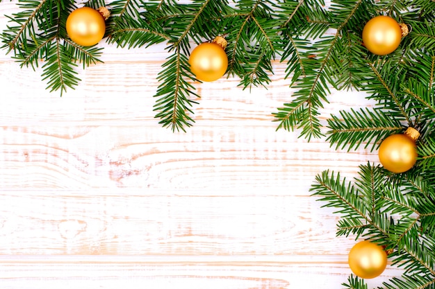 Christmas fir tree on white wooden background.