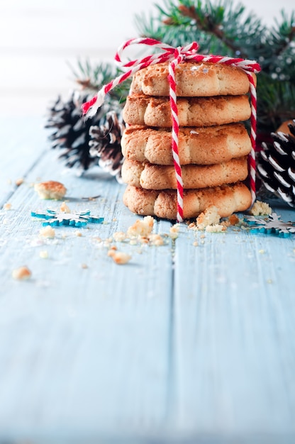 Christmas fir tree with cookies and decoration on a wooden board