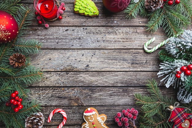 Christmas fir tree with decoration on dark wooden board