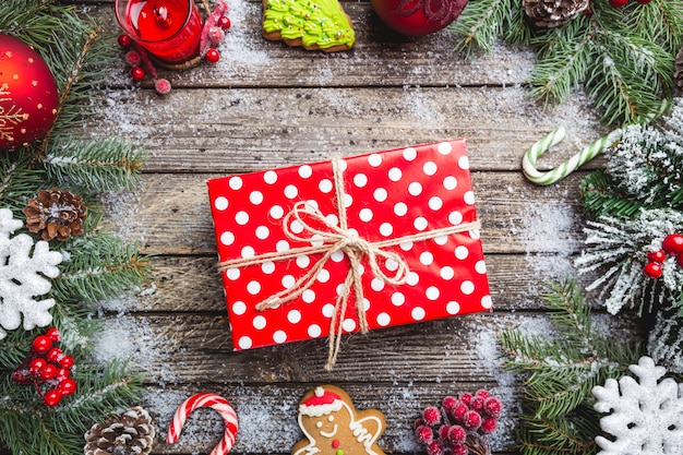 Christmas fir tree with decoration on dark wooden board