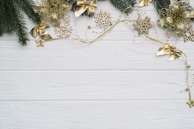 Christmas fir tree with decoration and glitters on wooden background.