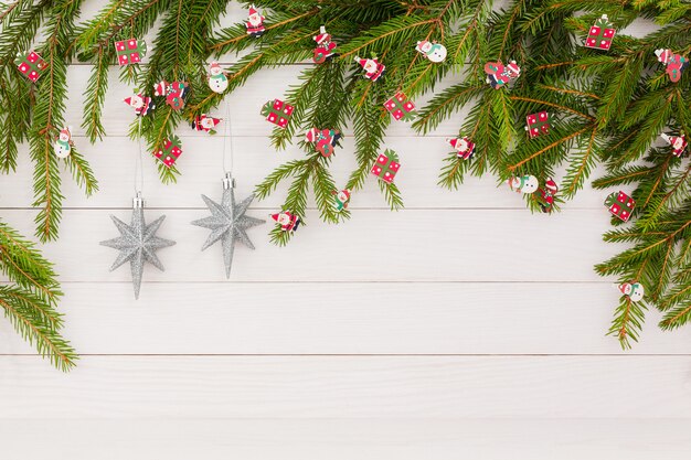 Christmas fir tree with decoration on white wooden background with copy space. Christmas background