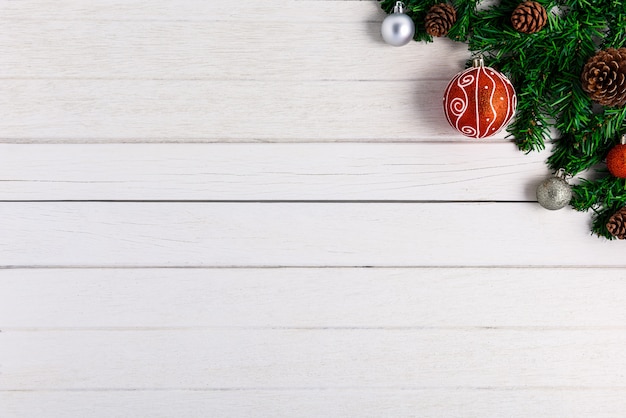 Christmas fir tree with decoration on white wooden board