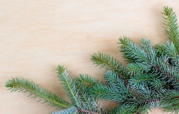 Christmas fir tree with decoration on a wooden board. Copy space. Selective focus.