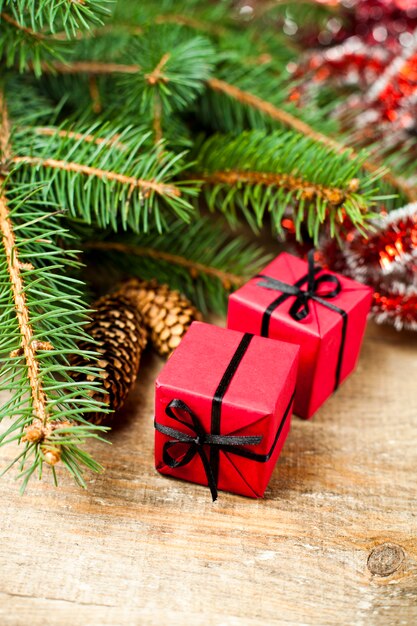 Christmas fir tree with pinecones and decorative boxes.