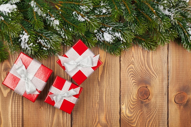 눈과 빨간 선물 상자가 있는 크리스마스 전나무