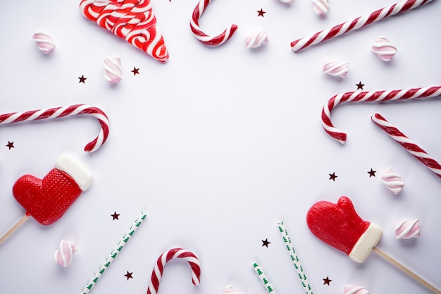 Christmas flat lay composition. Christmas candies with marshmallows on gray.