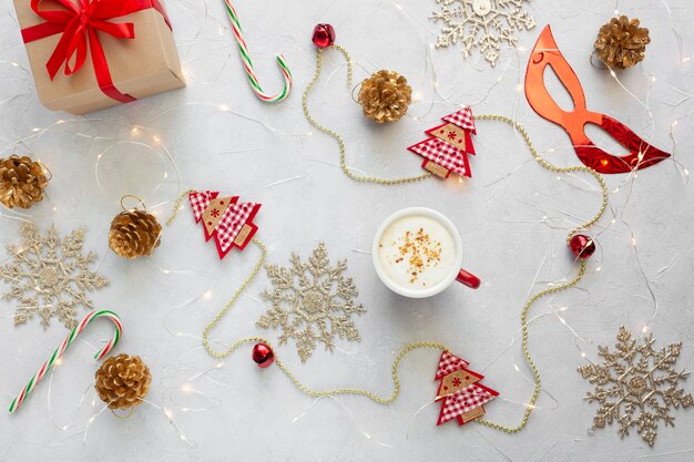 Christmas flat lay with cup of coffee and decorations.