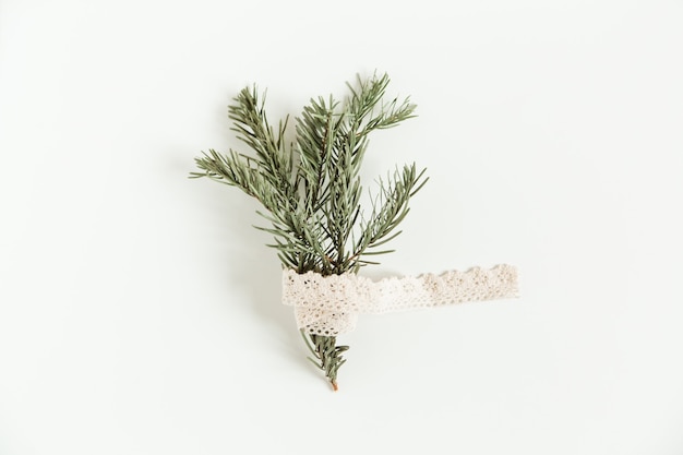 Christmas flat lay with fir pine branches with knitted lace on the white background