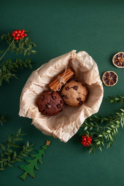 Christmas flowers and cookies in basket on isolated green background