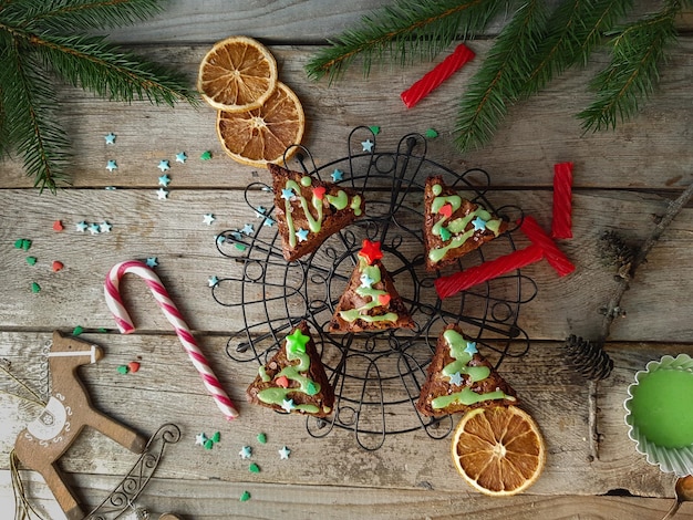 Christmas food ides delicious chocolate brownies in shape of christmas fir tree on rustic wooden background Cozy home decoration concept top view selective focus