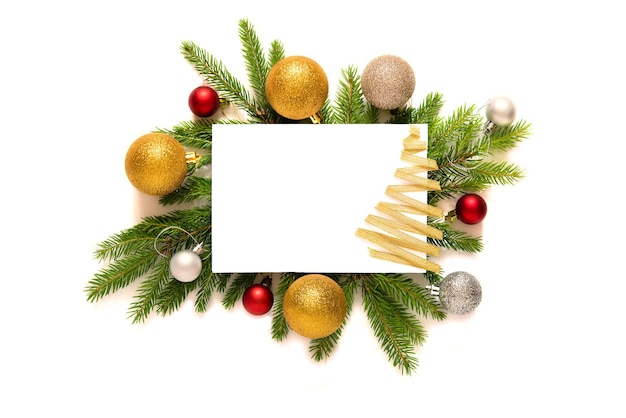 Christmas frame made of Christmas tree branche, Christmas toys and pine cones on a white background