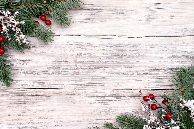 Christmas frame made of fir tree branches, berries.