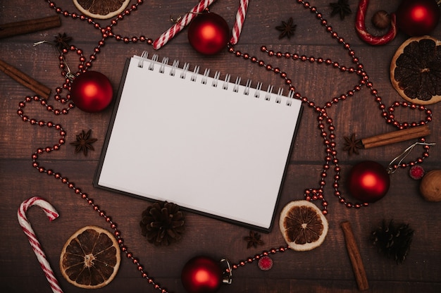 Christmas frame, in the style of flatley with a top view with Christmas decorations made of balls, cones, spices. The concept of celebrating the New Year.