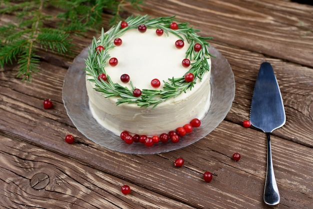 Christmas fruit cake, pudding on plate with rosemary and cranberry dcor