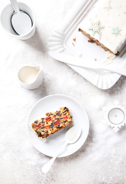 Christmas Fruit Cake, Pudding on snowy background . New Year pastries 