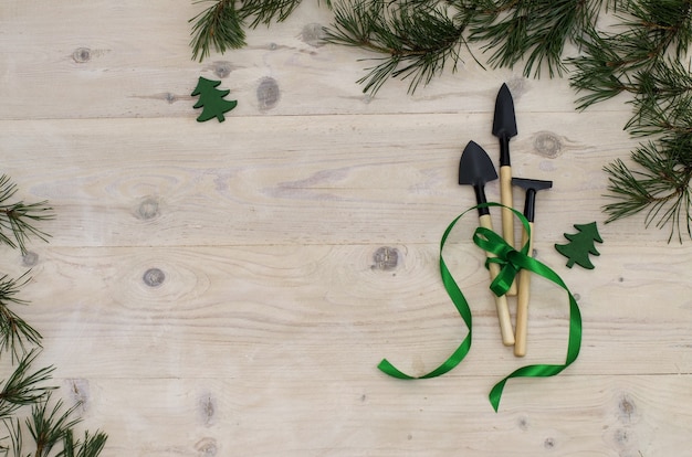 Christmas gardening tools on white wooden table Top view flat lay