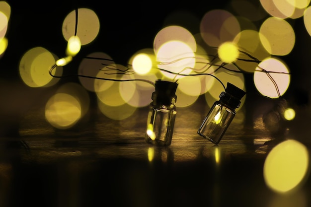 Christmas garland of glass bottles New year and christmas concept A garland of light bulbs with a beautiful light and bokeh