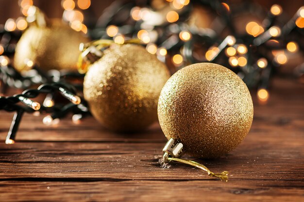 Christmas garland and gold balls on the wooden table