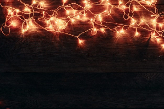 Christmas garland, lying on a wooden table. Holidays christmas . copyspace . View from above.