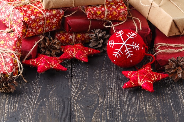 Christmas gift box. Christmas presents in red boxes at wooden table.