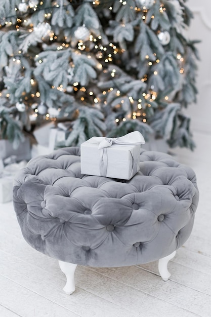 Christmas gift box on grey pouf