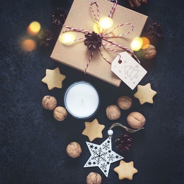 Christmas gift box and holiday decorations on black background