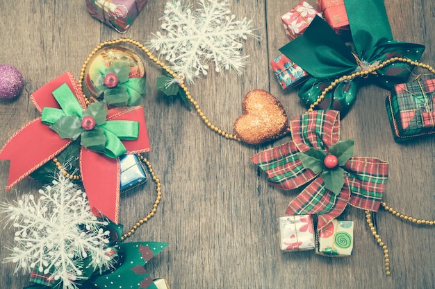 Christmas gift box and ribbon with heart sign on wood