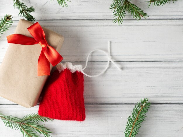 Christmas gift box and small gift bag on the table