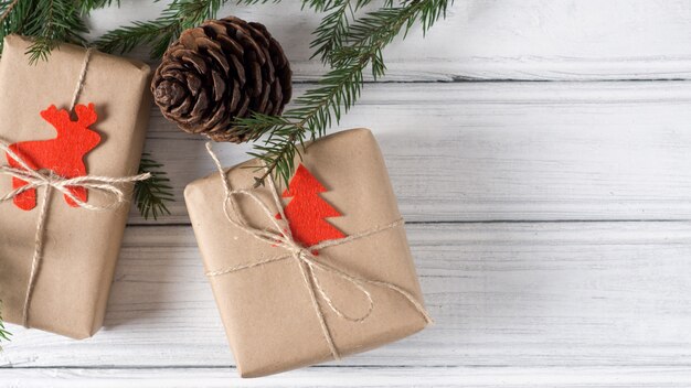 Christmas gift box on table with Christmas tree branches