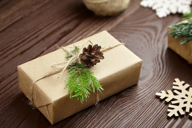 Christmas gift box with decorations wrapped in craft paper