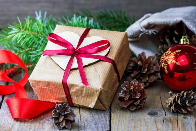 Christmas gift box with fir branches and cones