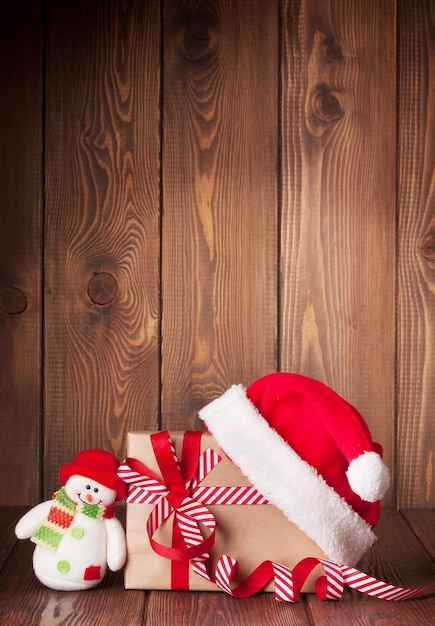 Christmas gift box with santa hat and snowman