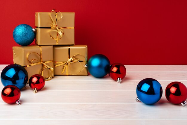 Christmas gift boxes against red background front view