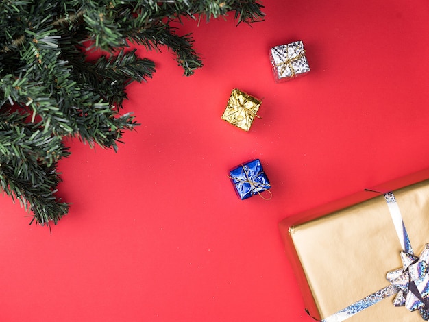 Christmas gift boxes and christmas tree on red background. Tradition ornament.