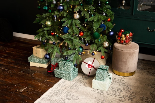 Christmas gift boxes under the Christmas tree with green blue and red Christmas balls at home