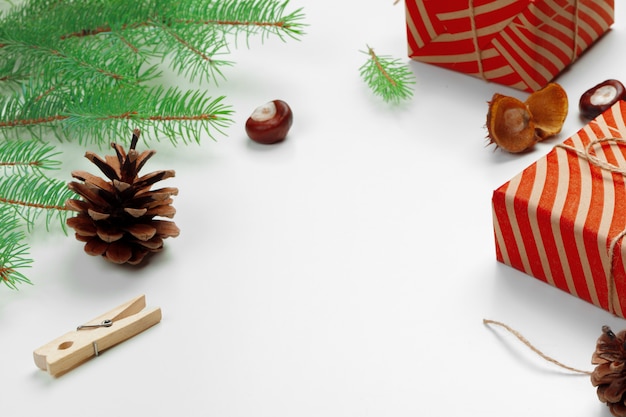 Christmas gift boxes decorated with cone on white background