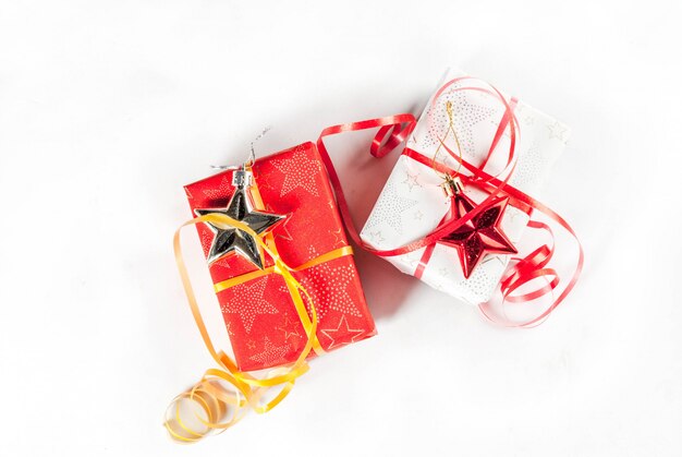 Christmas gift boxes and decorations on white background, top view