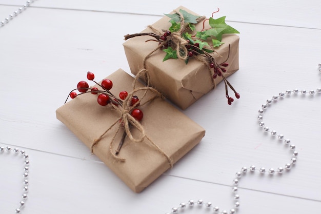 Christmas gift boxes and fir tree branch on wooden table Shristmas background