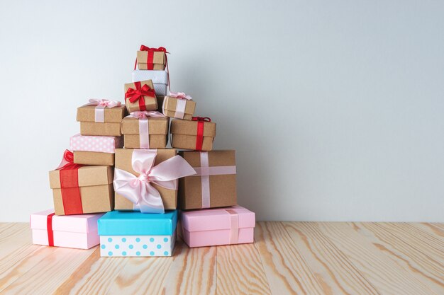 Photo christmas gift boxes laid out in the shape of a christmas tree