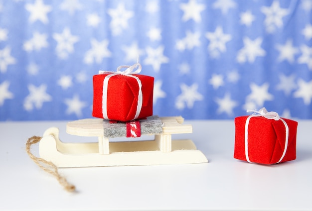 Christmas gift boxes on santa claus sleigh, on blue background